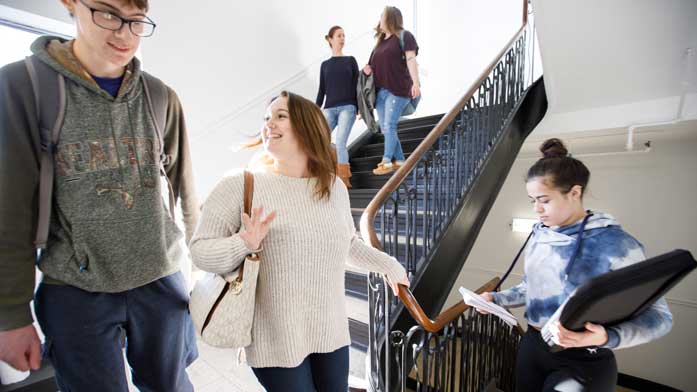 students in a hallway staircase