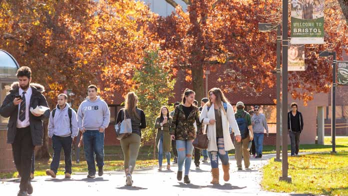 students walking outside on campus in the fall